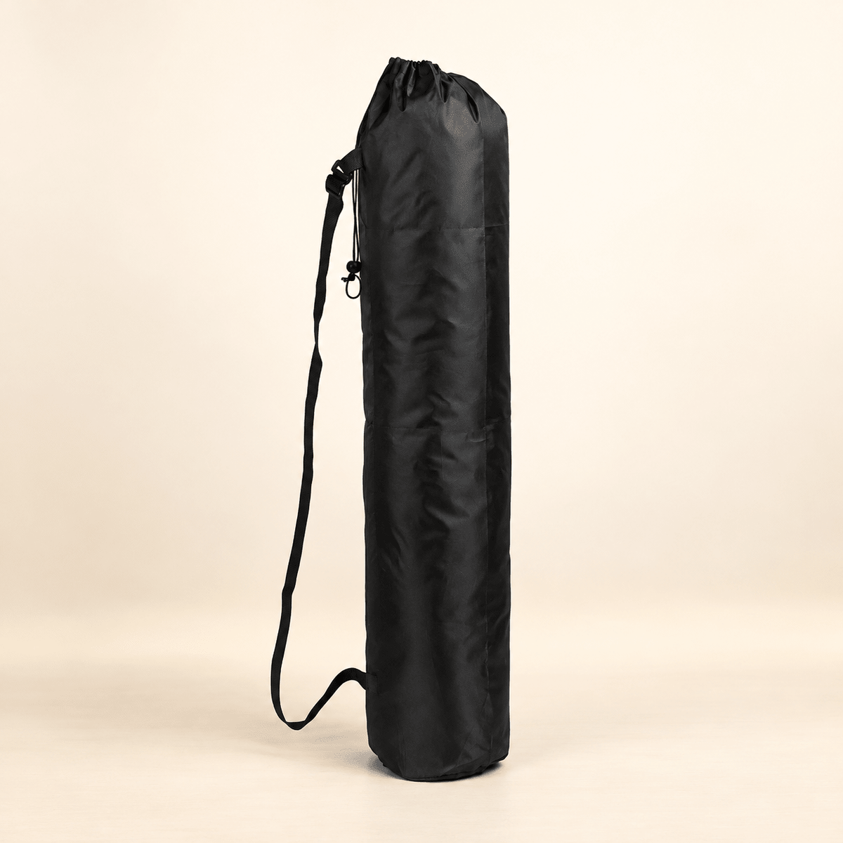 Black round-bottom mahjong mat storage bag with drawstring closure and carry strap on a warm ivory background