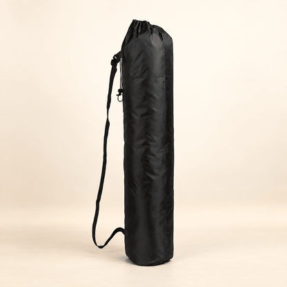 Black round-bottom mahjong mat storage bag with drawstring closure and carry strap on a warm ivory background