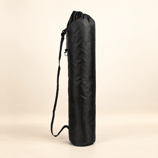 Black round-bottom mahjong mat storage bag with drawstring closure and carry strap on a warm ivory background