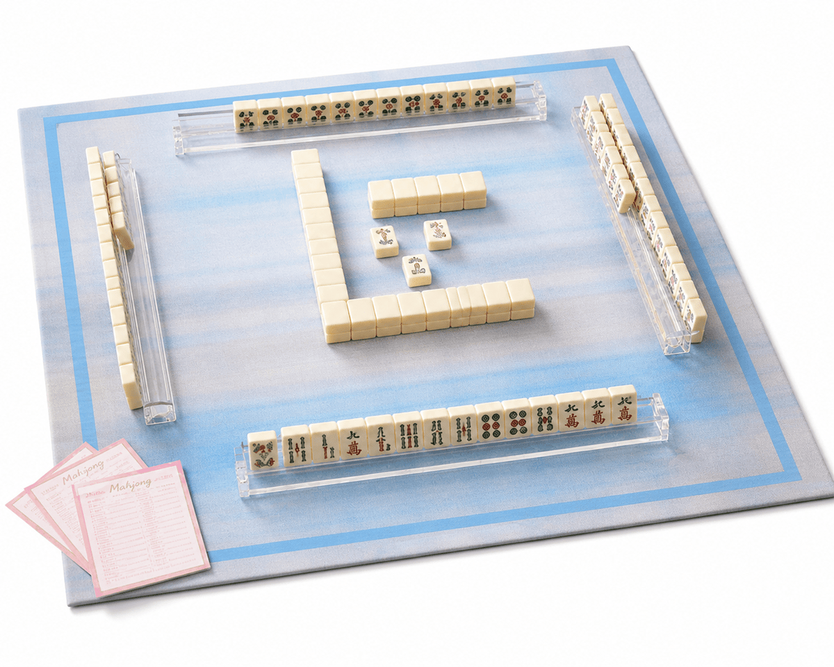 Blue plaid mahjong mat displayed with mahjong tiles, clear racks, dice, and scorecards.
