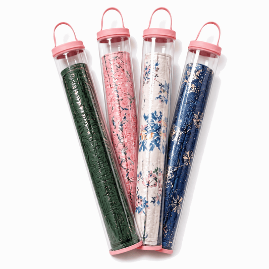 Four clear PVC mahjong mat storage bags with light pink trim and rolled floral mats