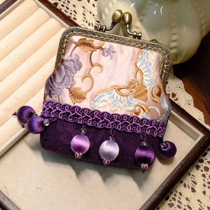 Purple and pale pink embroidered coin purse with a brass clasp and purple bead tassels.