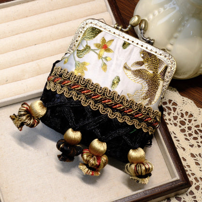 Black and gray vintage coin purse with fish embroidery, brass clasp, and gold tassels.