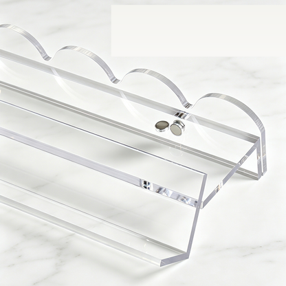 Close-up of a clear mahjong rack and scalloped pusher showing the round attachment points.